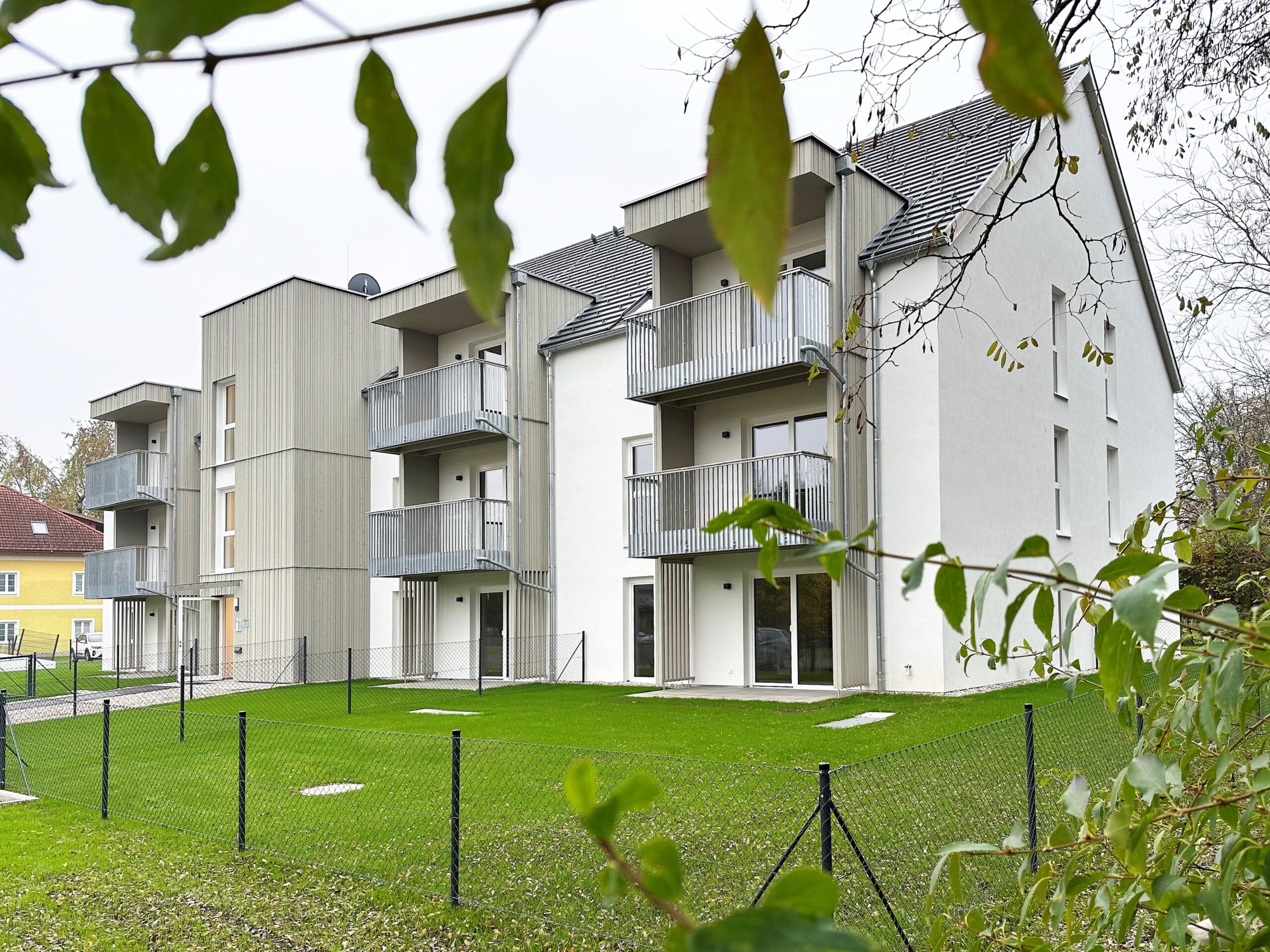 Wohnbau in Massivholz mit Balkonen und Terrassen, Holzfassade, Balkone mit Metallgeländer, Vorvergrautes Holz